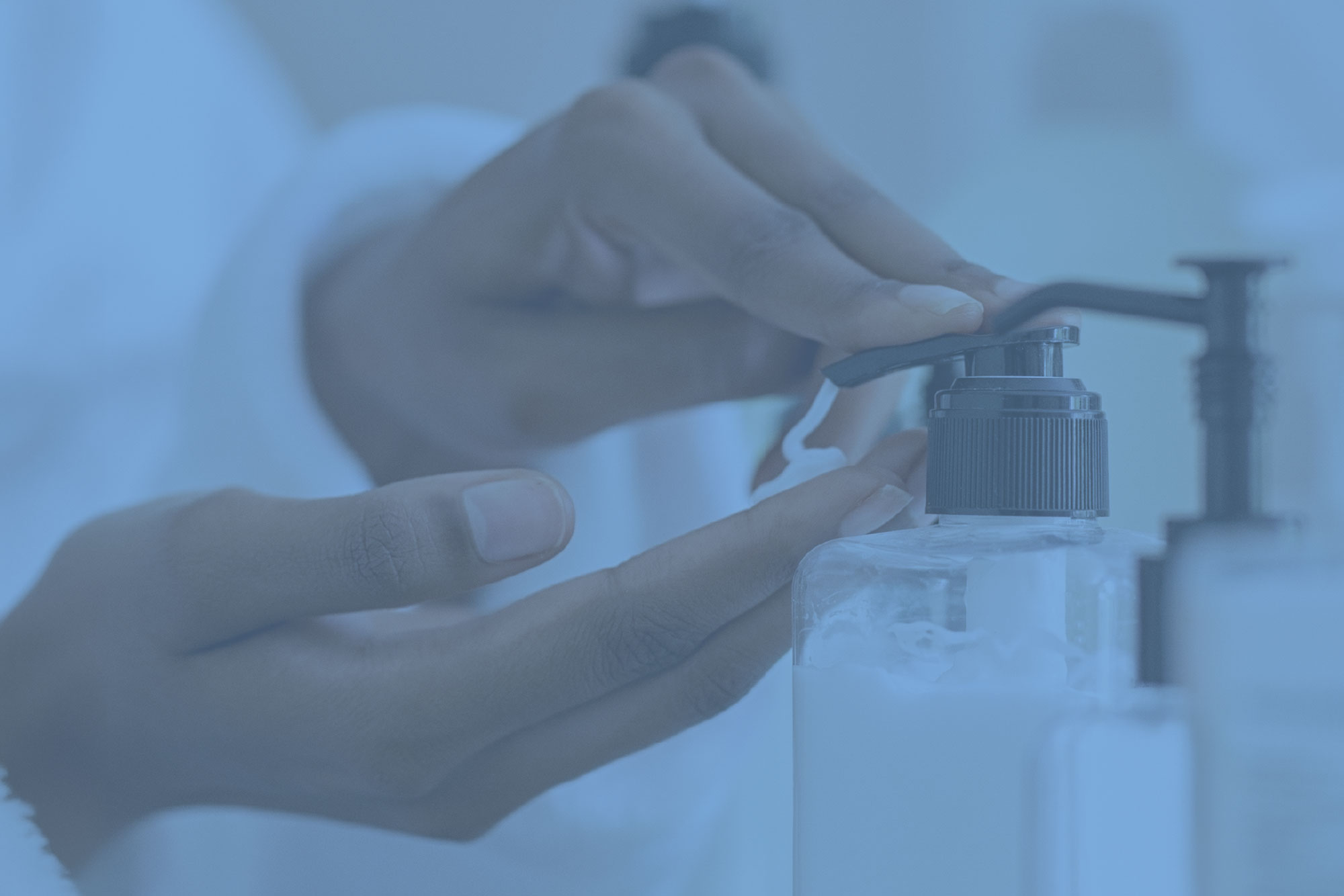 hand pushing soap from dispenser with blue overlay